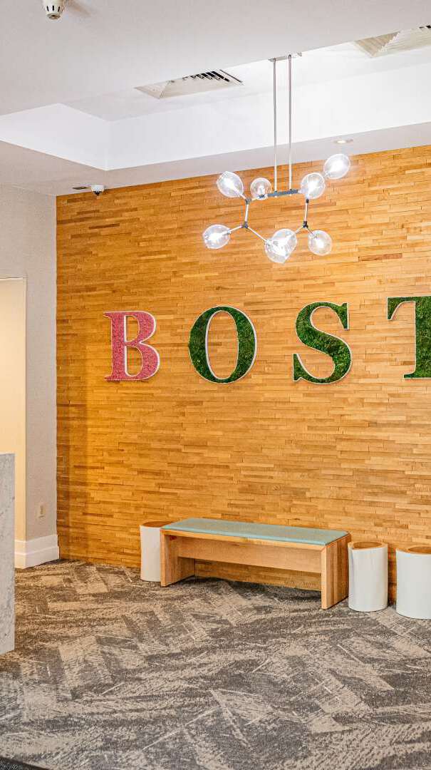 The Inn at Longwood Medical lobby with the word "Boston" on the wall