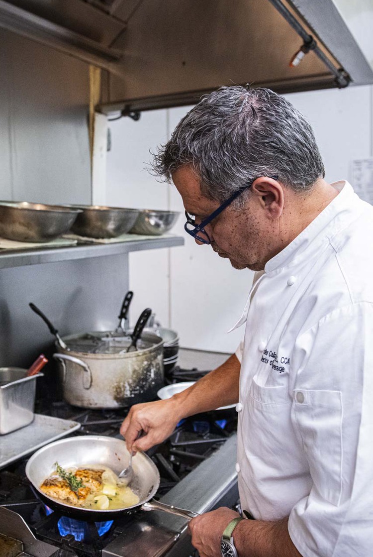 Chef cooking food over a fire