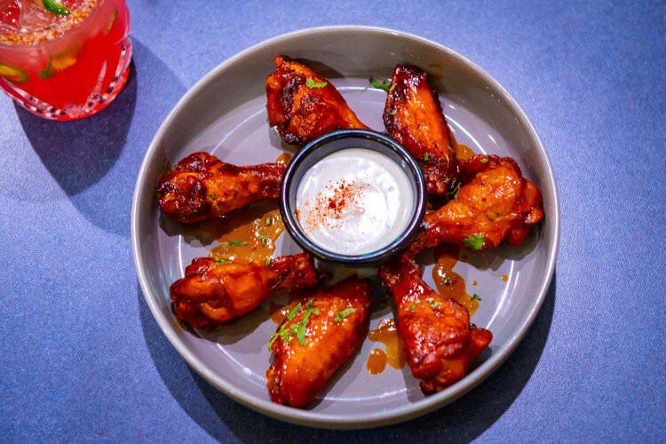 Chicken wings plated with sauce