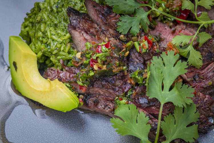 Meat dish with avocado and garnish