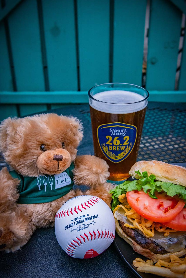 Hope teddy bear beside beer, burger, and a baseball