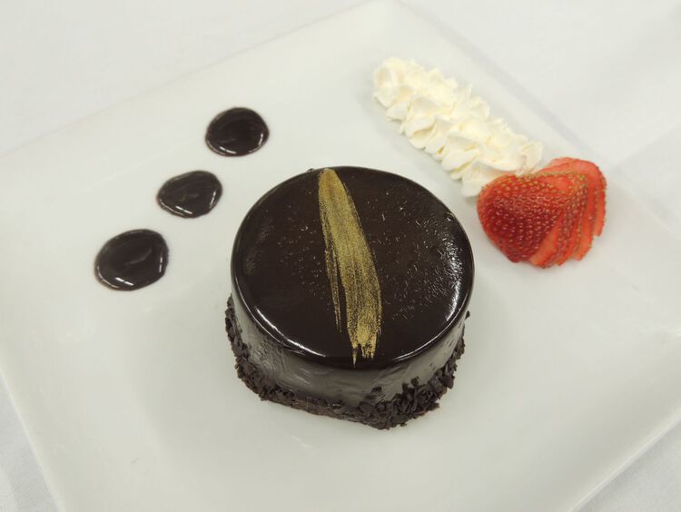 Chocolate cake with dtrawberry on the side