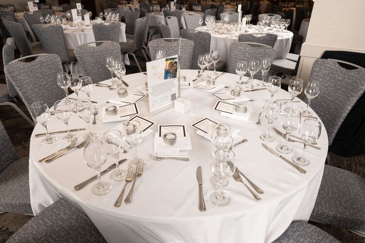 Dining table setup with white tablecloth