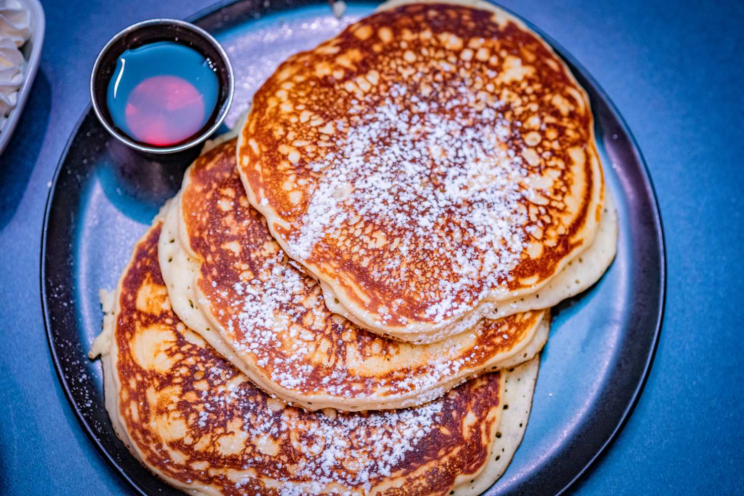 A plate of pancakse and maple syrup