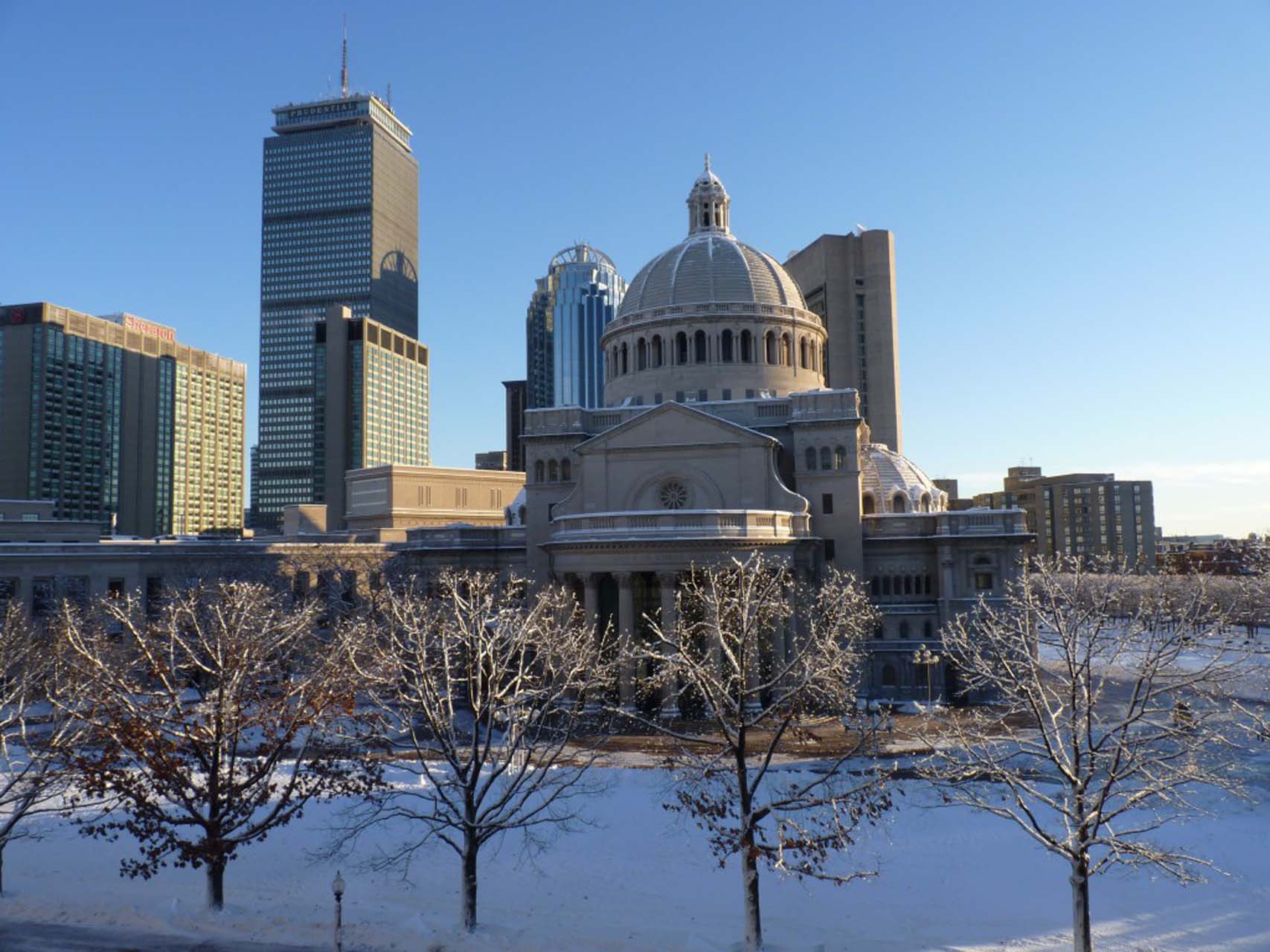 a city skyline with a large domed building in the center